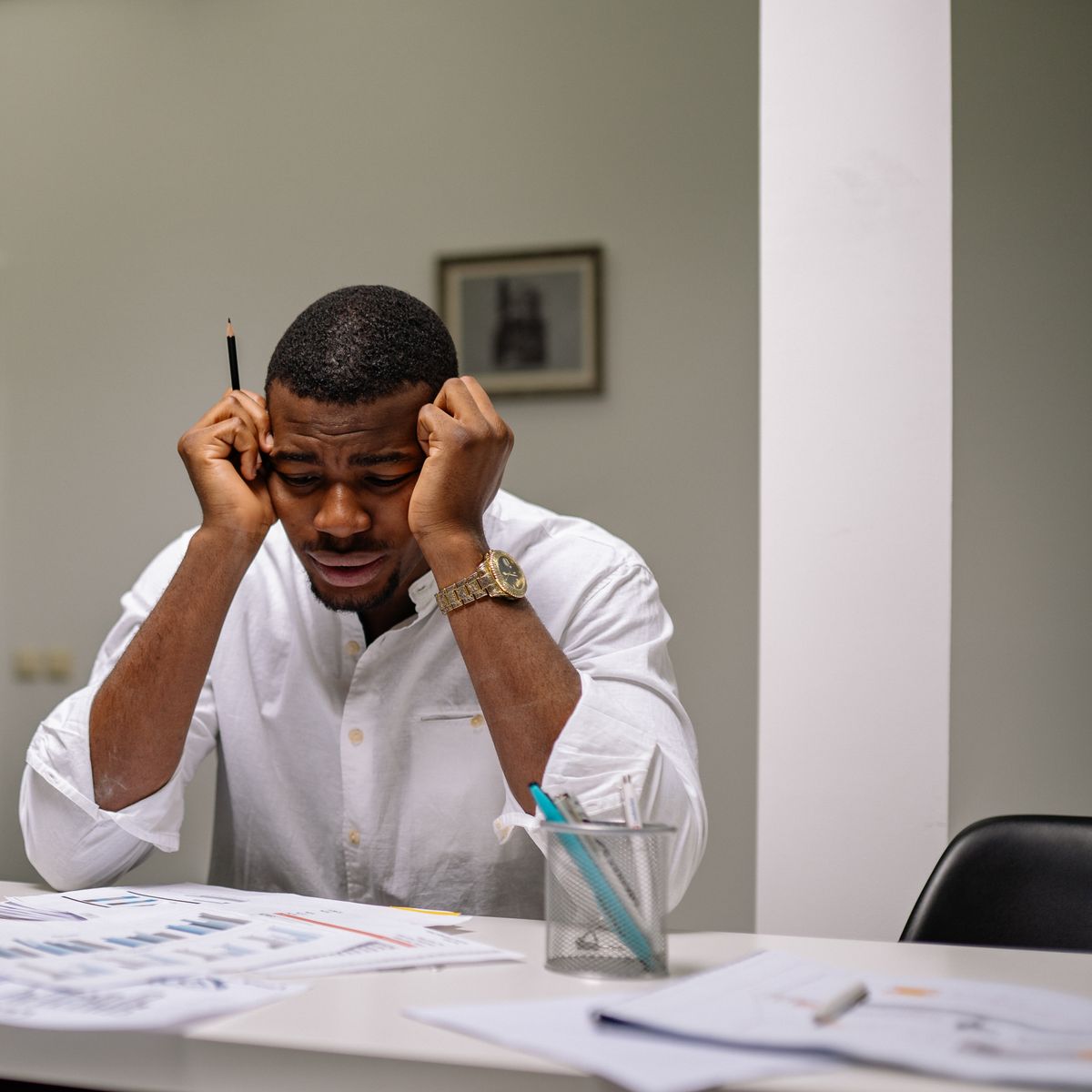 An adult feeling overwhelmed at a desk